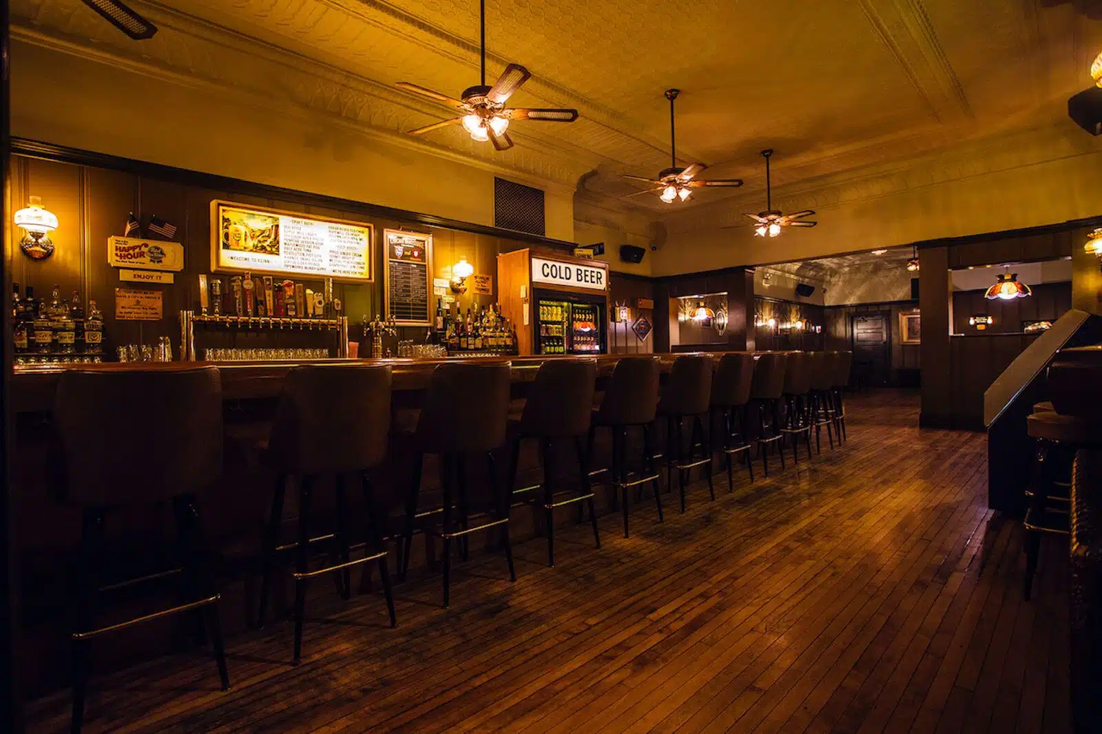 Interior del EZ con nevera de cerveza fría, fila de grifos en la barra y suelos de madera