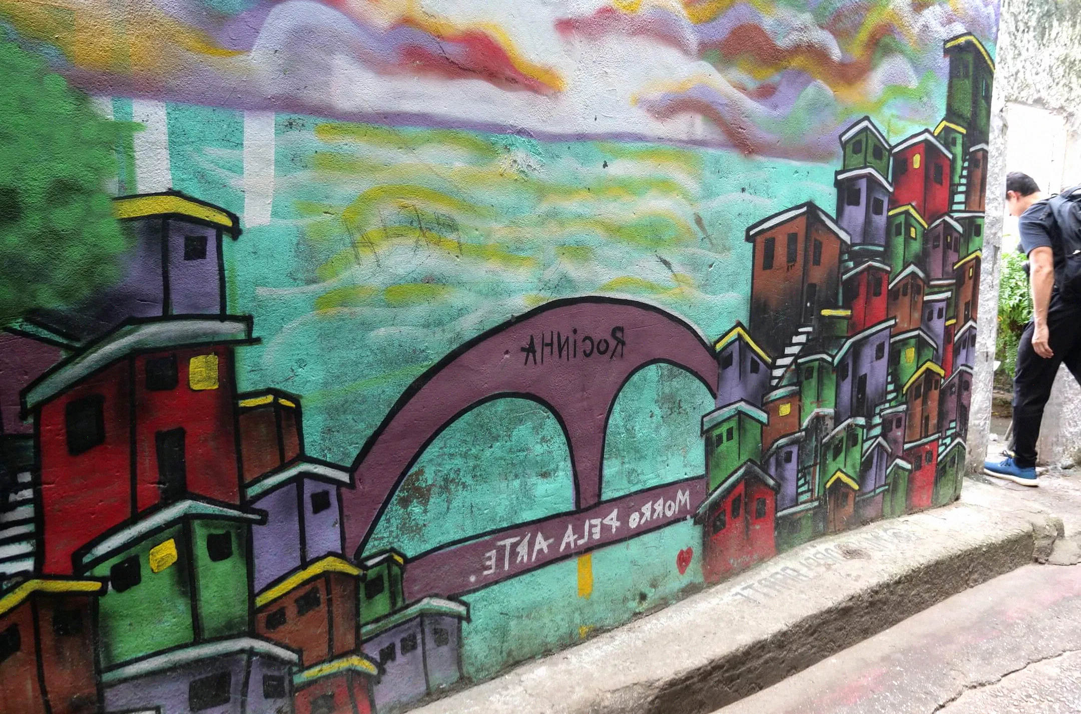Mira las siguientes fotos para ver la Puerta del Cielo. Esta foto muestra algunas obras de arte que representan la entrada a la propia favela de Rocinha, visibles en la distancia muy por debajo.